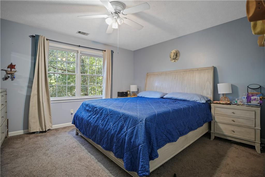 4880 Racquet Court Duluth, GA 30096 - Photo 16 of 22 a bedroom with a bed and window