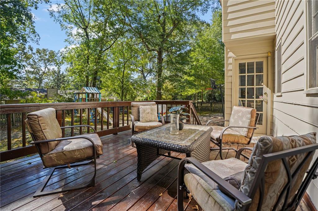 4880 Racquet Court Duluth, GA 30096 - Photo 21 of 22 a view of a patio with lawn chairs next to a yard