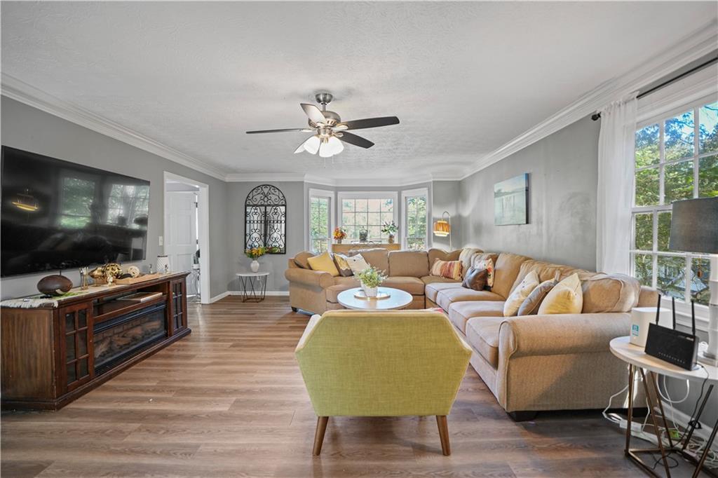 4880 Racquet Court Duluth, GA 30096 - Photo 4 of 22 a living room with furniture and a flat screen tv