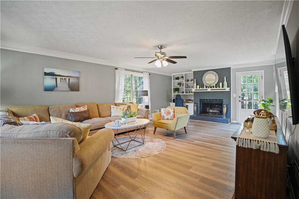 4880 Racquet Court Duluth, GA 30096 - Photo 6 of 22 a living room with furniture and a fireplace