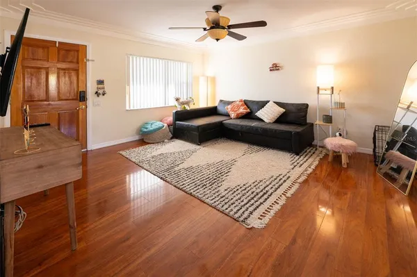 a living room with furniture rug and wooden floor