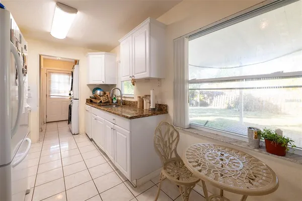 a kitchen with a stove a sink and a refrigerator