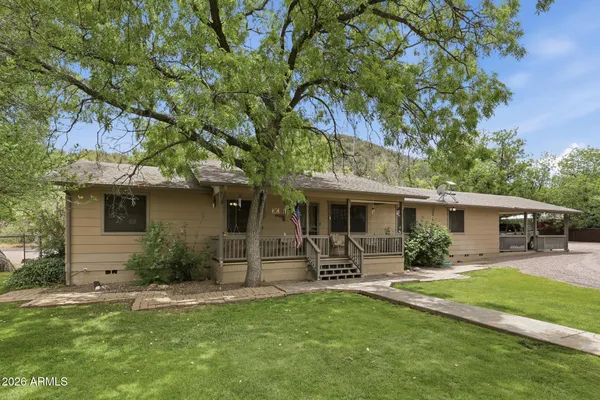 a front view of house with yard and outdoor seating