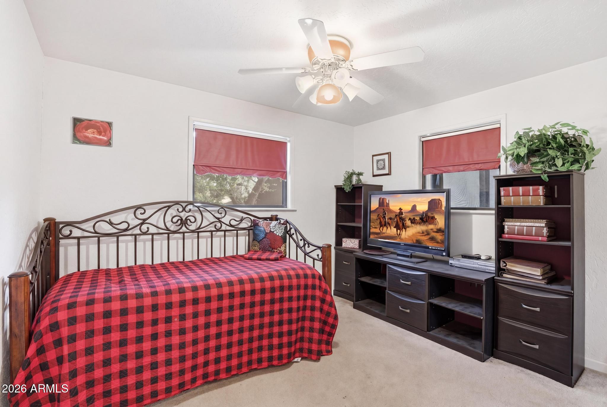 7736 West Gibson Ranch Road Payson, AZ 85541 - Photo 27 of 51 a bedroom with a bed and a flat screen tv