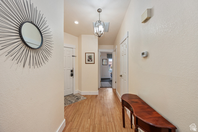 677 Ridge Rim Way, Unit 20 St. George, UT 84770 - Photo 11 of 20 Corridor with a chandelier, and light wood finished floors