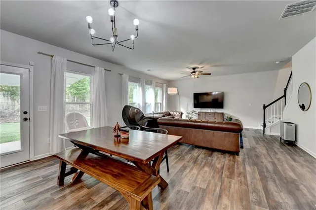 a view of a dining room with furniture window and wooden floor