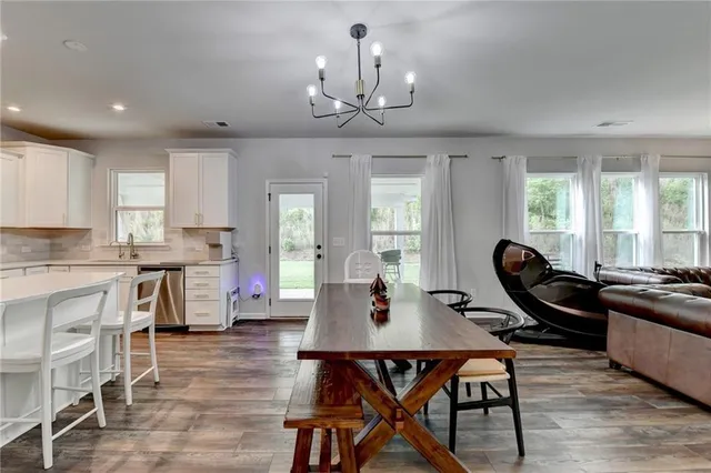 a view of a dining room with furniture window and wooden floor