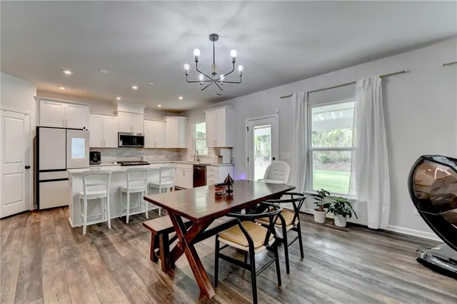 a living room with furniture ceiling fan and a flat screen tv