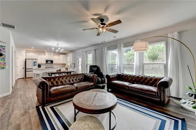 a kitchen with a sink a stove a refrigerator and cabinets