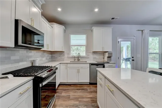 a kitchen with a sink cabinets and appliances