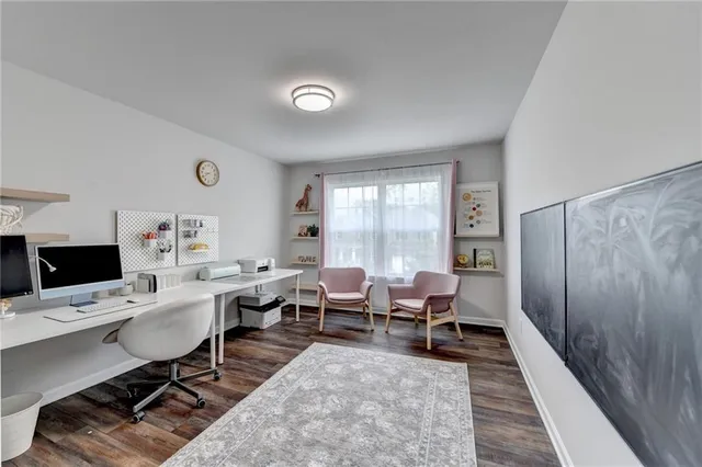 a bedroom with a bed and a large mirror next to a window