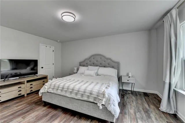 a bedroom with a bed and ceiling fan