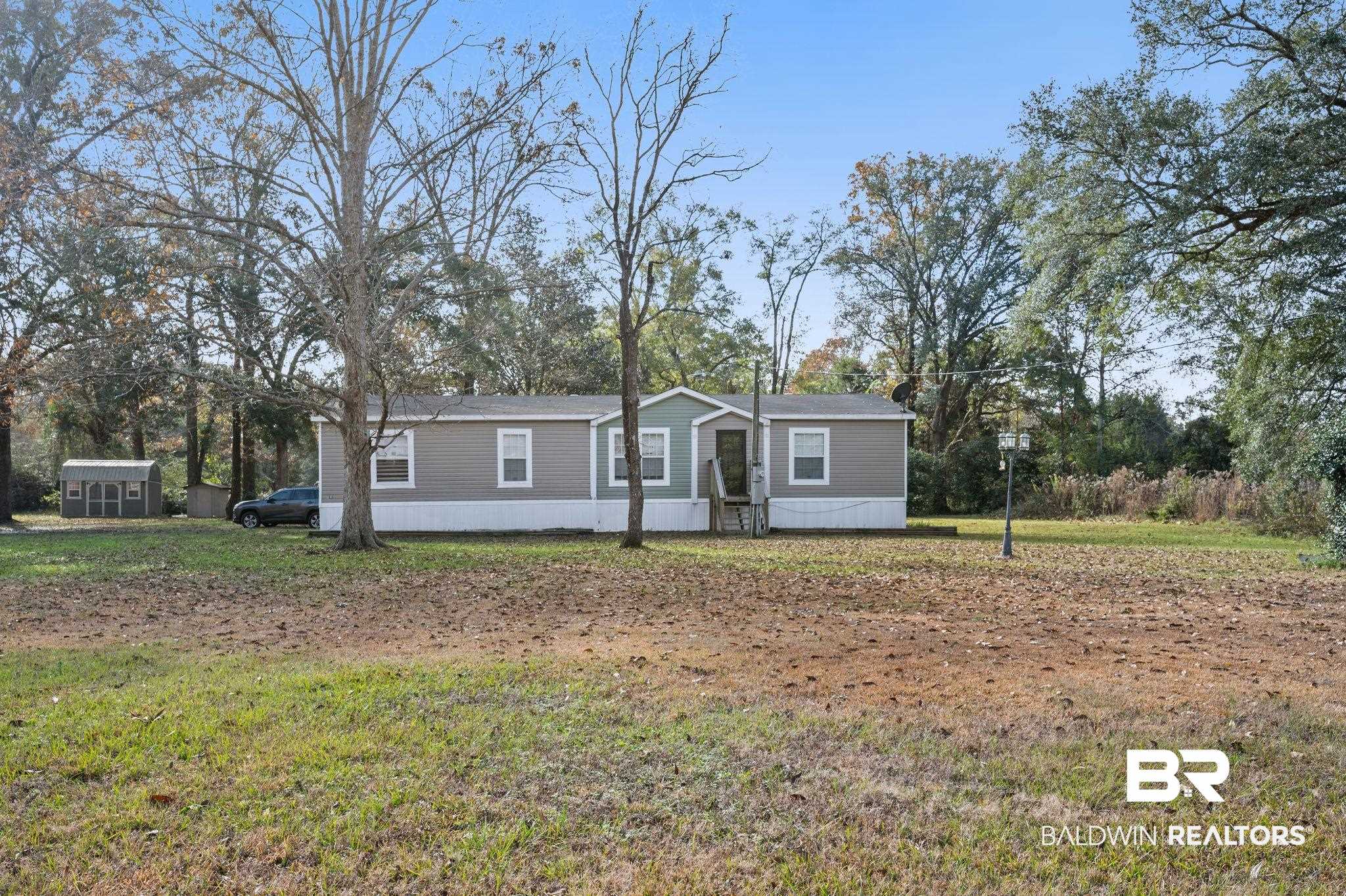9382 D'Olive Street Bay Minette, AL 36507 - Photo 1 of 27 Manufactured / mobile home featuring a front lawn and a shed