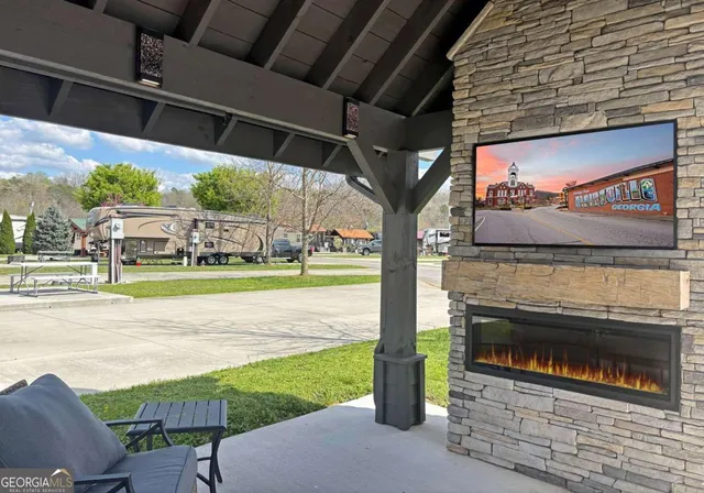 a view of a porch with furniture and a yard