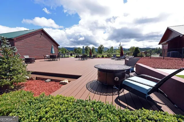 a backyard of a house with table and chairs