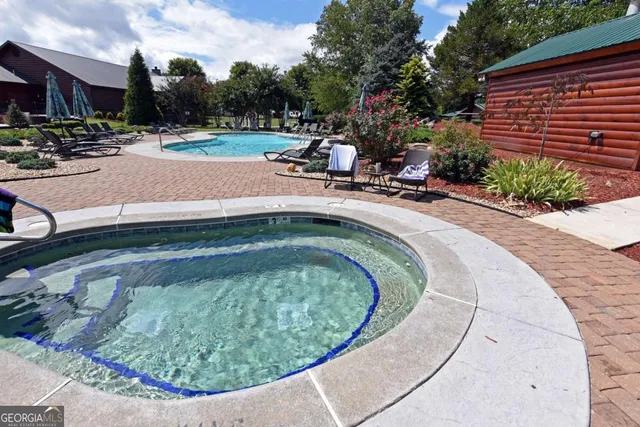 a view of a swimming pool with a patio