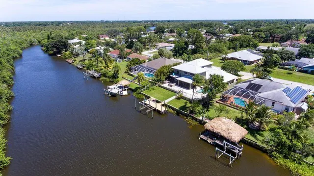 an aerial view of a houses with a lake view