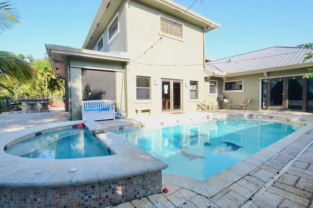 a view of a patio with table and chairs potted plants with wooden fence