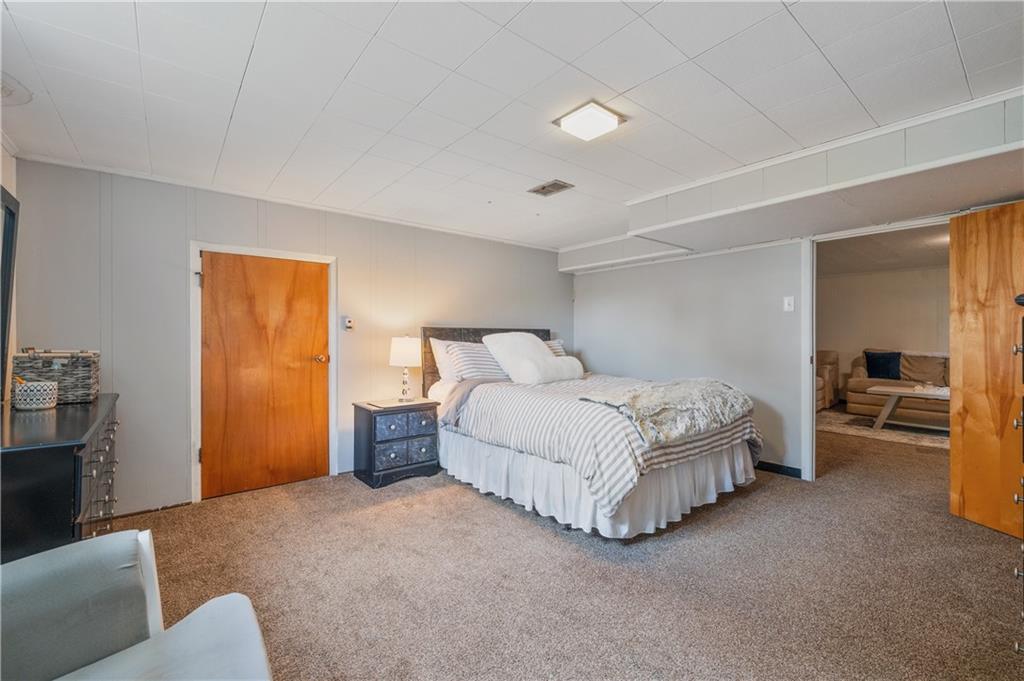30 Beaver Grade Road McKees Rocks, PA 15136 - Photo 15 of 26 a spacious bedroom with a bed and a couch