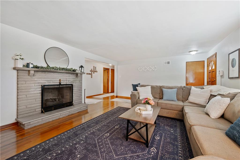 30 Beaver Grade Road McKees Rocks, PA 15136 - Photo 6 of 26 a living room with furniture a fireplace and a floor to ceiling window