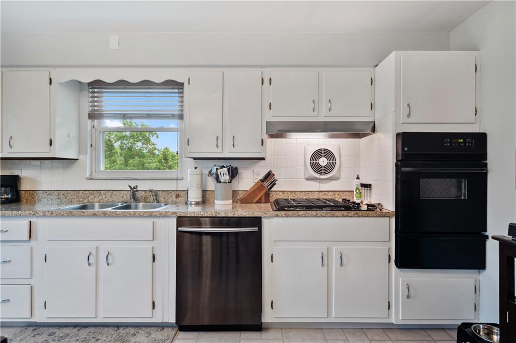 30 Beaver Grade Road McKees Rocks, PA 15136 - Photo 7 of 26 a kitchen with granite countertop white cabinets and white appliances