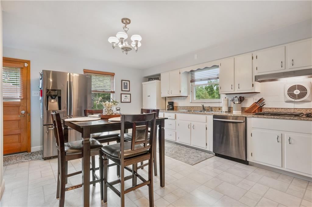 30 Beaver Grade Road McKees Rocks, PA 15136 - Photo 10 of 26 a kitchen with a table chairs refrigerator and cabinets