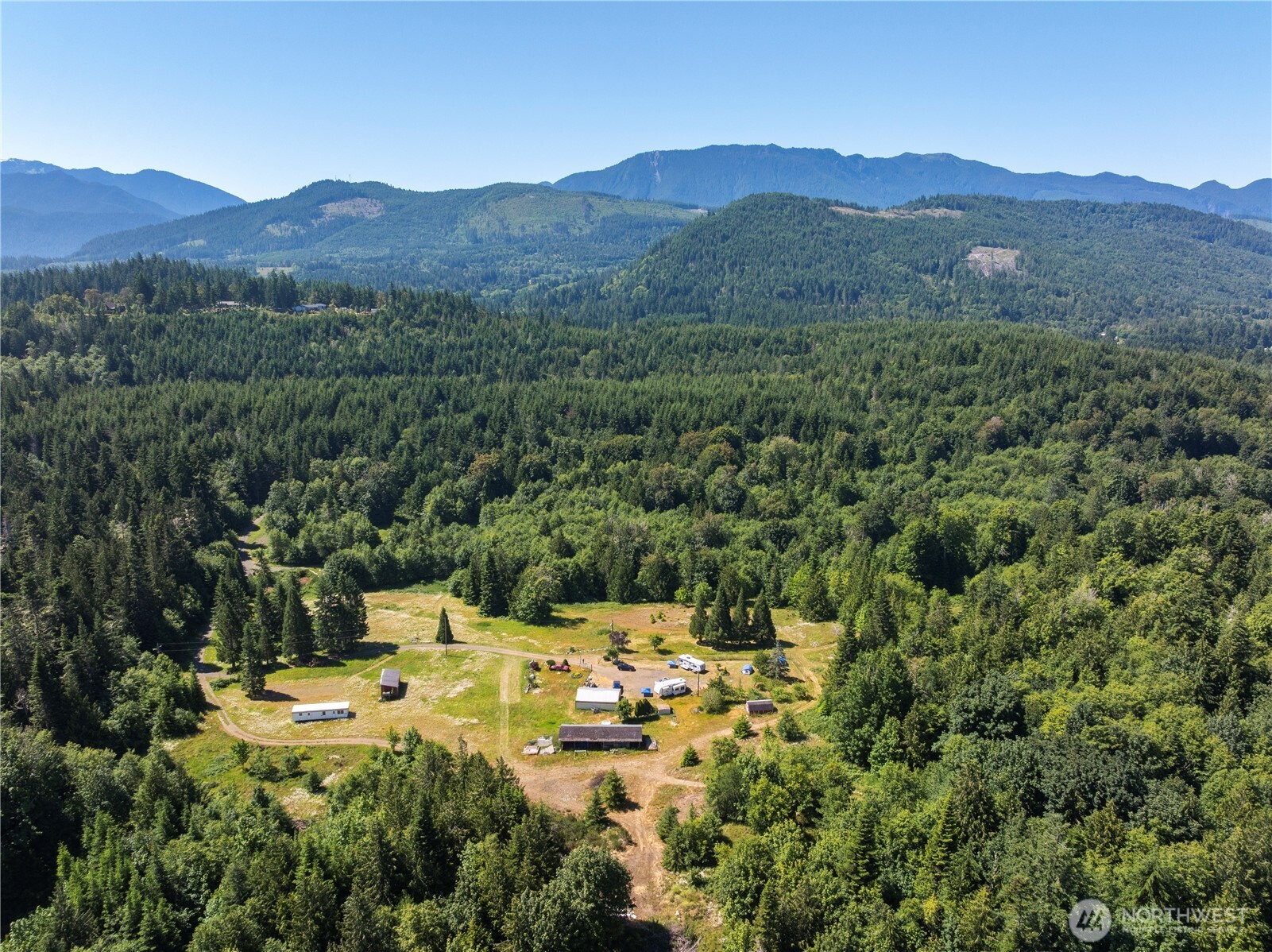 1048 Peters Road Port Angeles, WA 98363 - Photo 2 of 25 a view of a lush green hillside and houses
