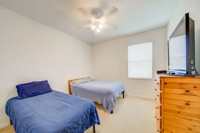 a bedroom with two beds and a window