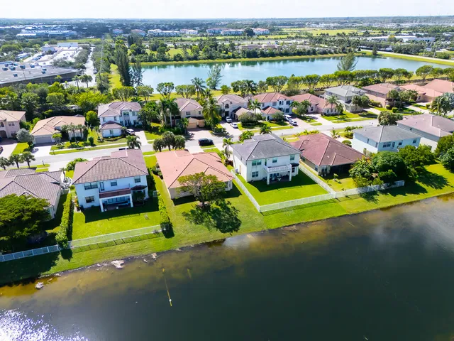 an aerial view of a houses with a lake view
