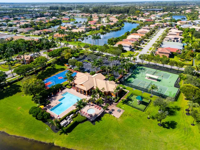 an aerial view of residential houses with outdoor space and swimming pool