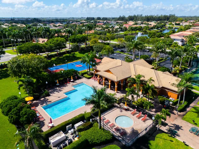 an aerial view of a house with a swimming pool yard and outdoor seating