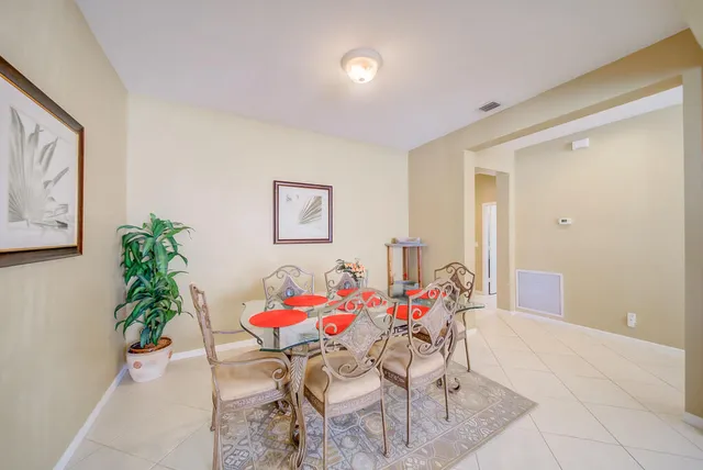 a dining room with furniture and flowers