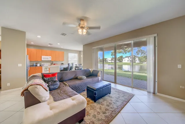 a living room with furniture and a floor to ceiling window