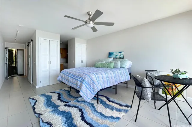 a bed room with a bed and a chair