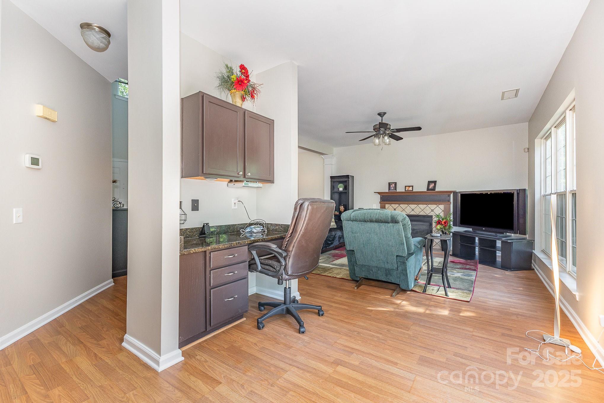 815 Clearbrook Road Matthews, NC 28105 - Photo 12 of 45 a workspace with furniture hardwood and a kitchen