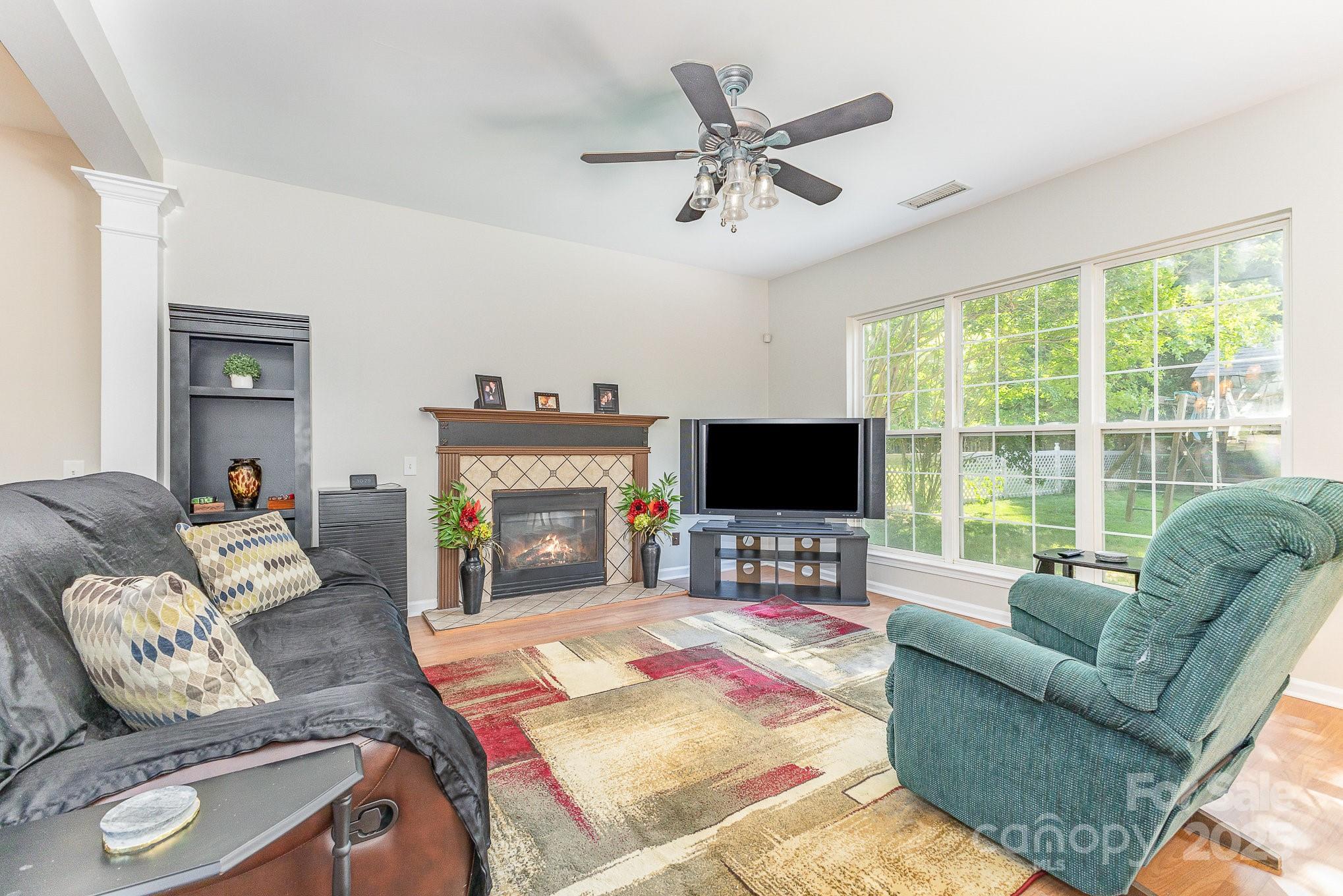 815 Clearbrook Road Matthews, NC 28105 - Photo 14 of 45 a living room with furniture a flat screen tv and a large window