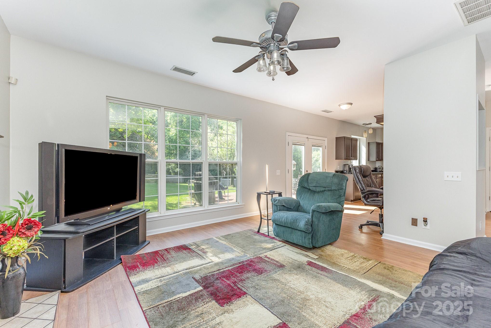 815 Clearbrook Road Matthews, NC 28105 - Photo 15 of 45 a living room with furniture and a flat screen tv