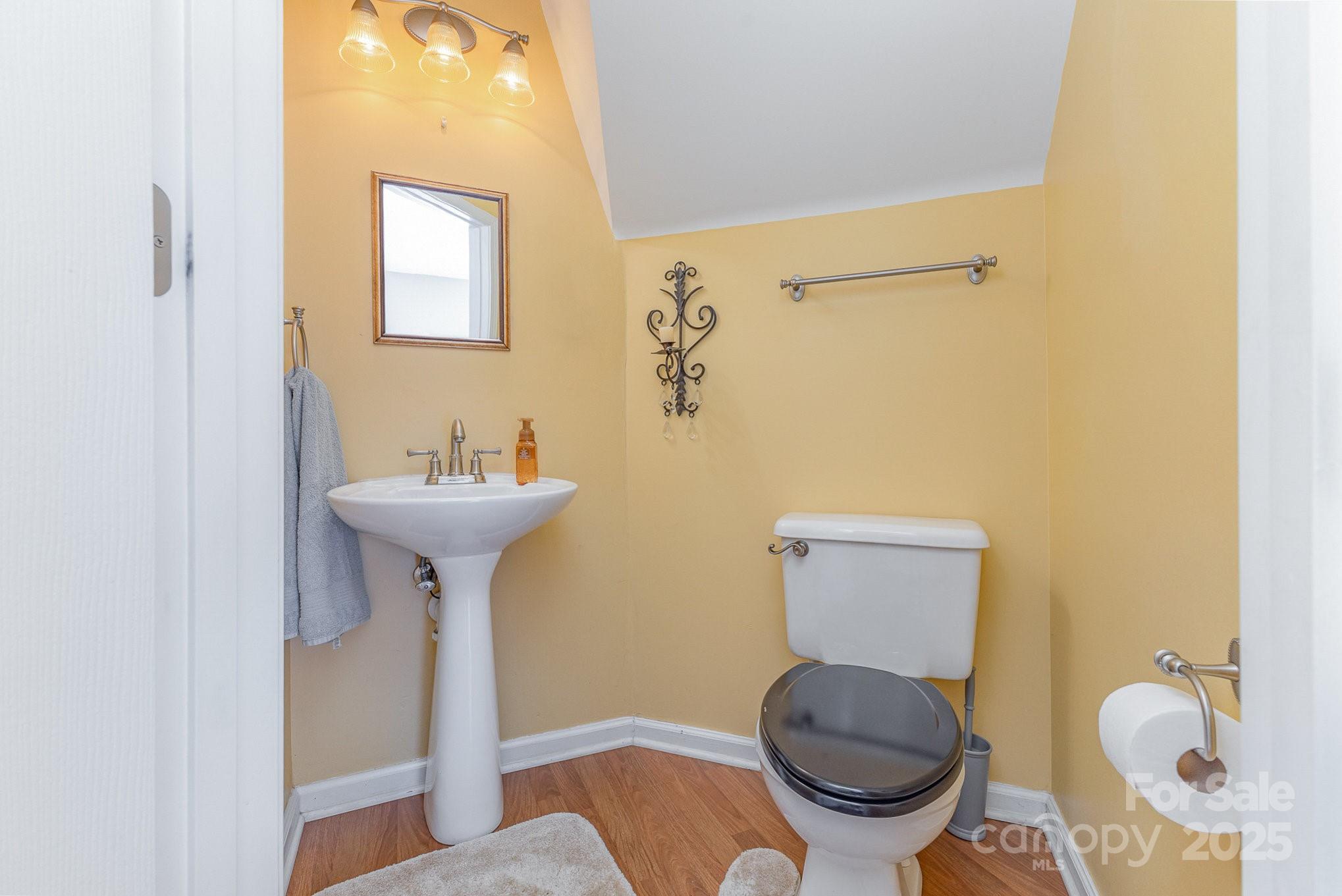 815 Clearbrook Road Matthews, NC 28105 - Photo 16 of 45 a bathroom with a toilet sink and mirror