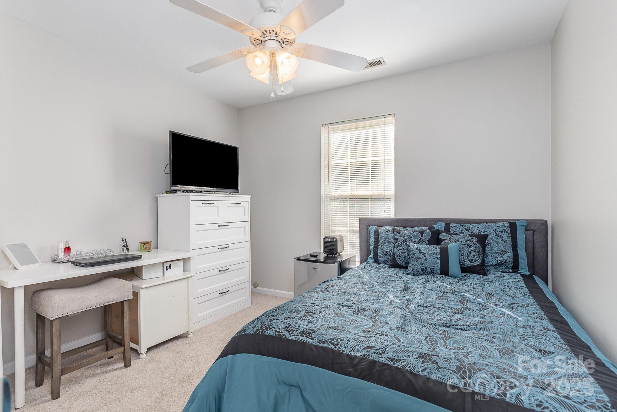 815 Clearbrook Road Matthews, NC 28105 - Photo 19 of 45 a bedroom with a bed and a flat screen tv