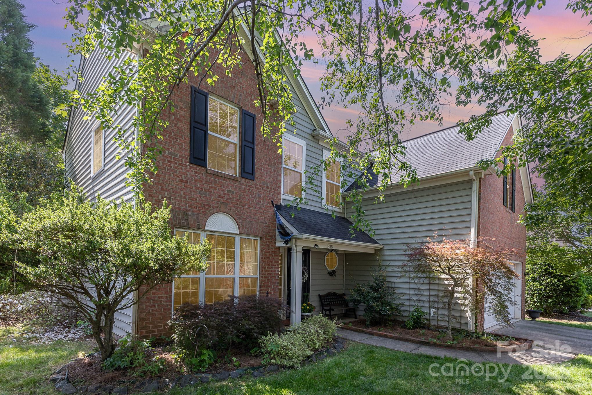 815 Clearbrook Road Matthews, NC 28105 - Photo 2 of 45 a view of a brick house with a large windows and a large tree