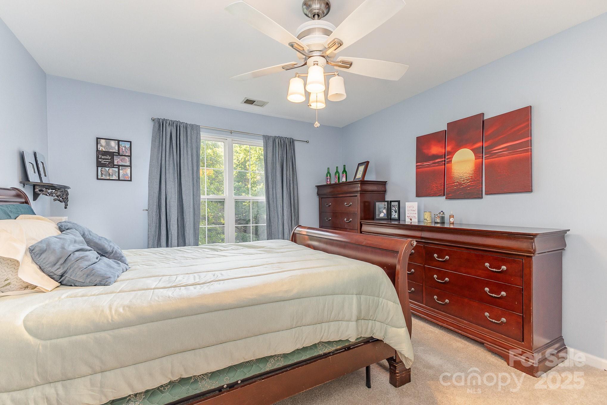 815 Clearbrook Road Matthews, NC 28105 - Photo 21 of 45 a bedroom with a bed and a dresser
