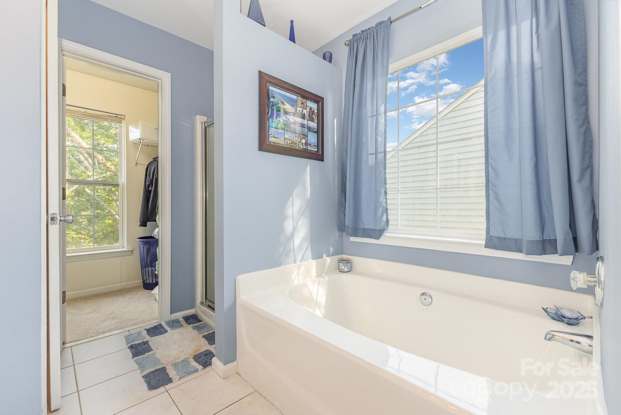 815 Clearbrook Road Matthews, NC 28105 - Photo 22 of 45 a bathroom with a bathtub and a shower