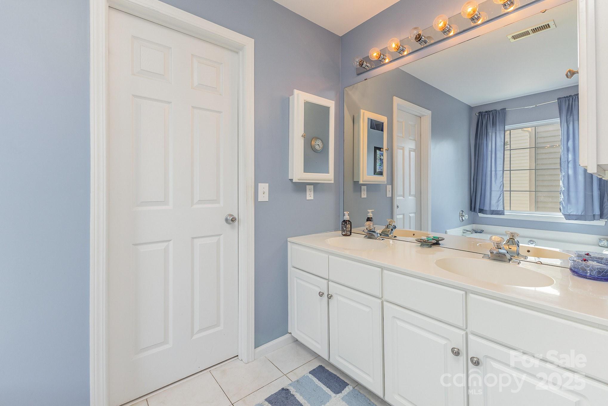 815 Clearbrook Road Matthews, NC 28105 - Photo 24 of 45 a bathroom with a double vanity sink and mirror