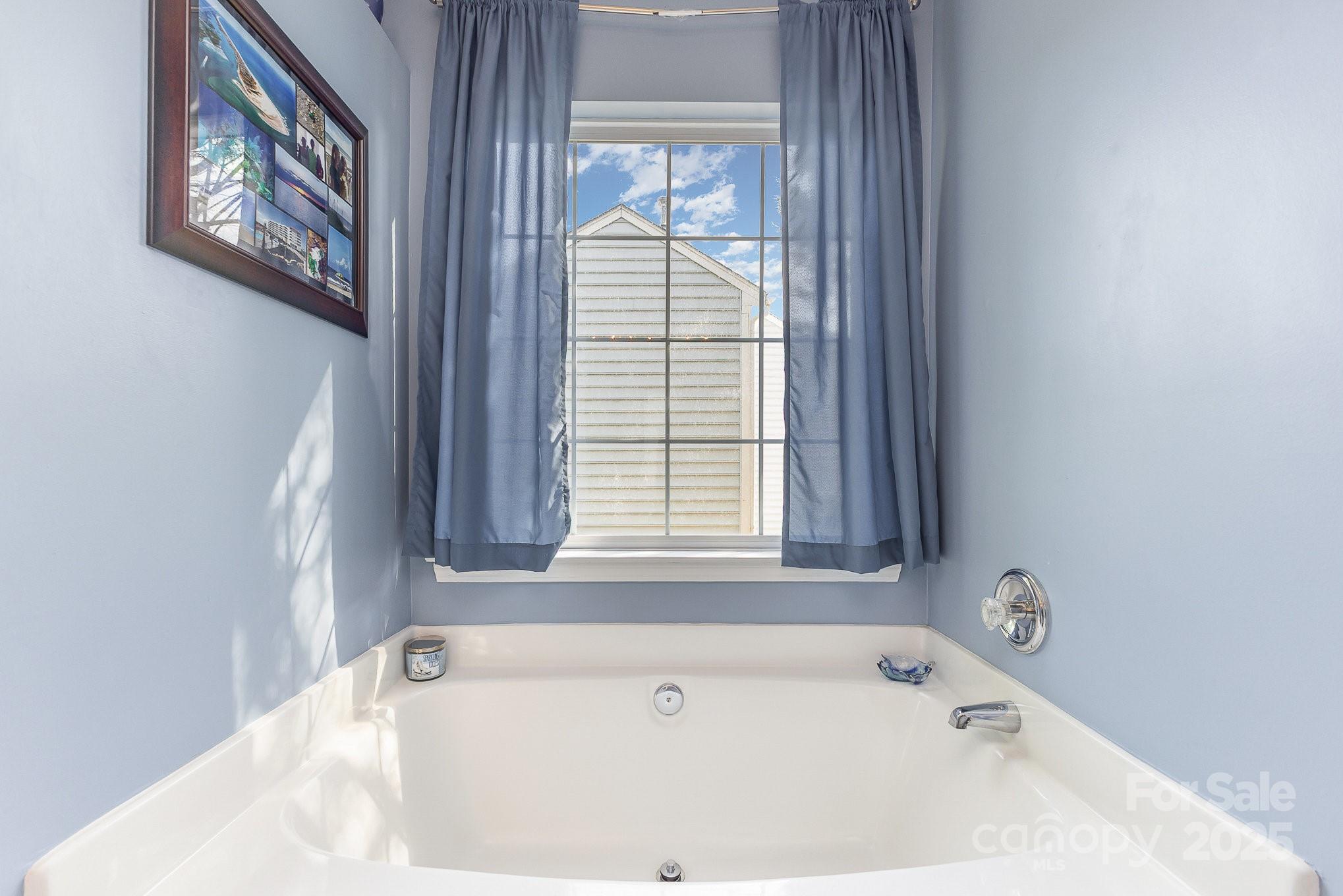 815 Clearbrook Road Matthews, NC 28105 - Photo 25 of 45 a bathroom with a bathtub and a window