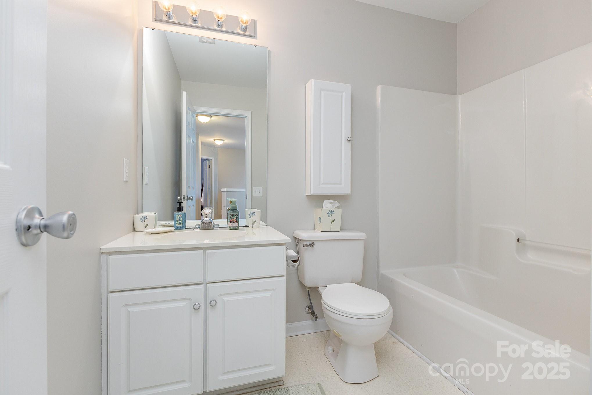815 Clearbrook Road Matthews, NC 28105 - Photo 30 of 45 a bathroom with a toilet sink vanity tub and mirror