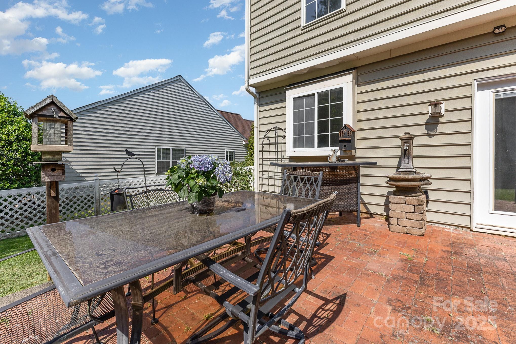 815 Clearbrook Road Matthews, NC 28105 - Photo 32 of 45 a backyard of a house with wooden floor chairs and wooden fence