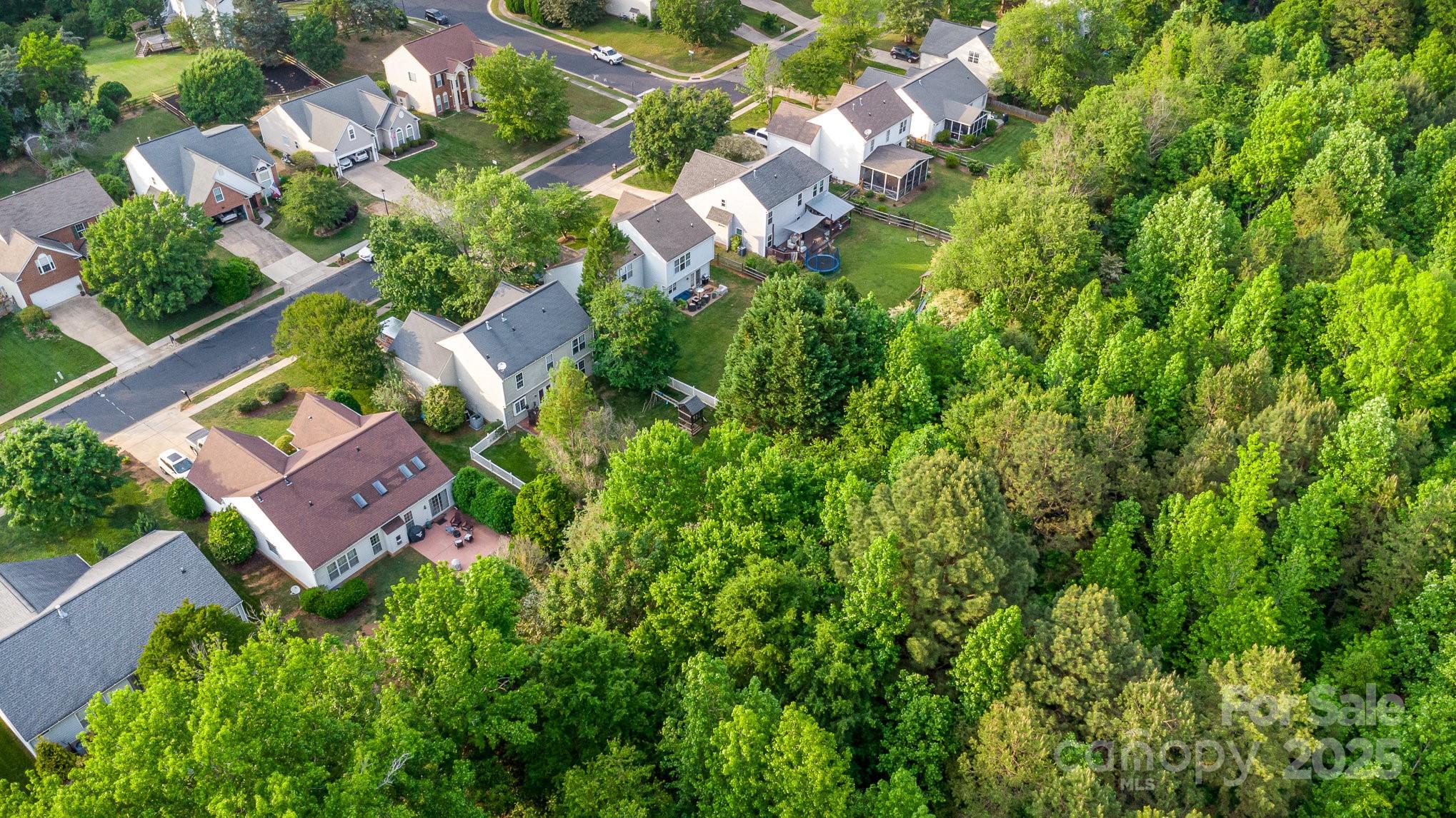 815 Clearbrook Road Matthews, NC 28105 - Photo 43 of 45 an aerial view of residential houses with outdoor space and trees all around