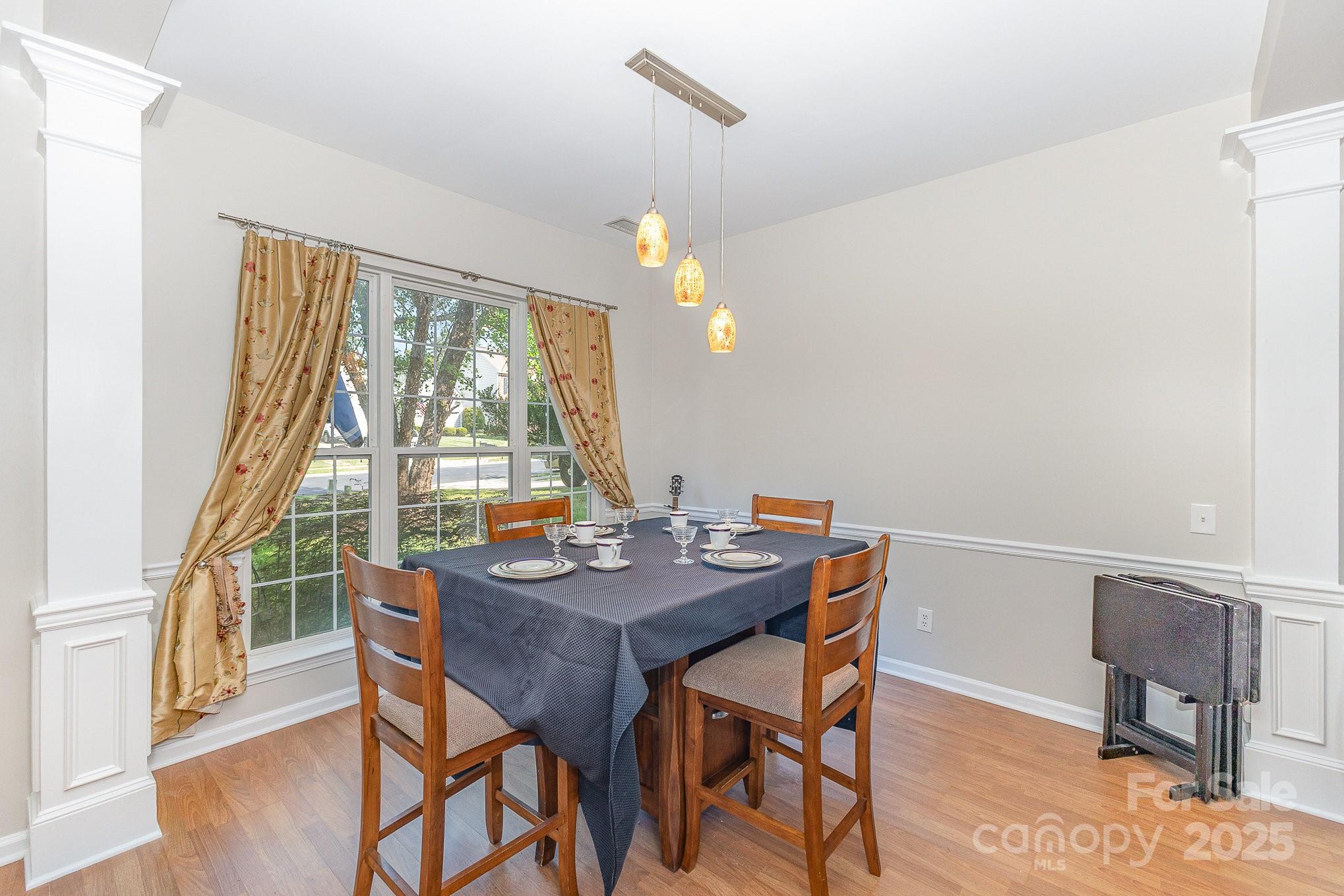815 Clearbrook Road Matthews, NC 28105 - Photo 7 of 45 a view of a dining room with furniture window and wooden floor