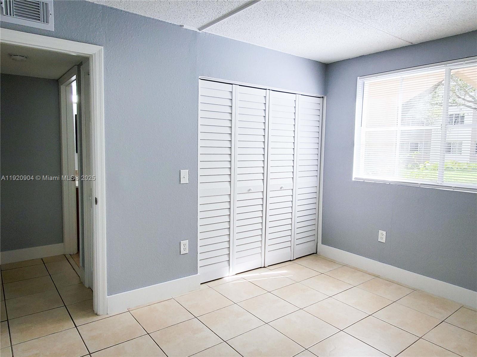6065 Northwest 186th Street, Unit 106 Hialeah, FL 33015 - Photo 11 of 20 a view of empty room with window