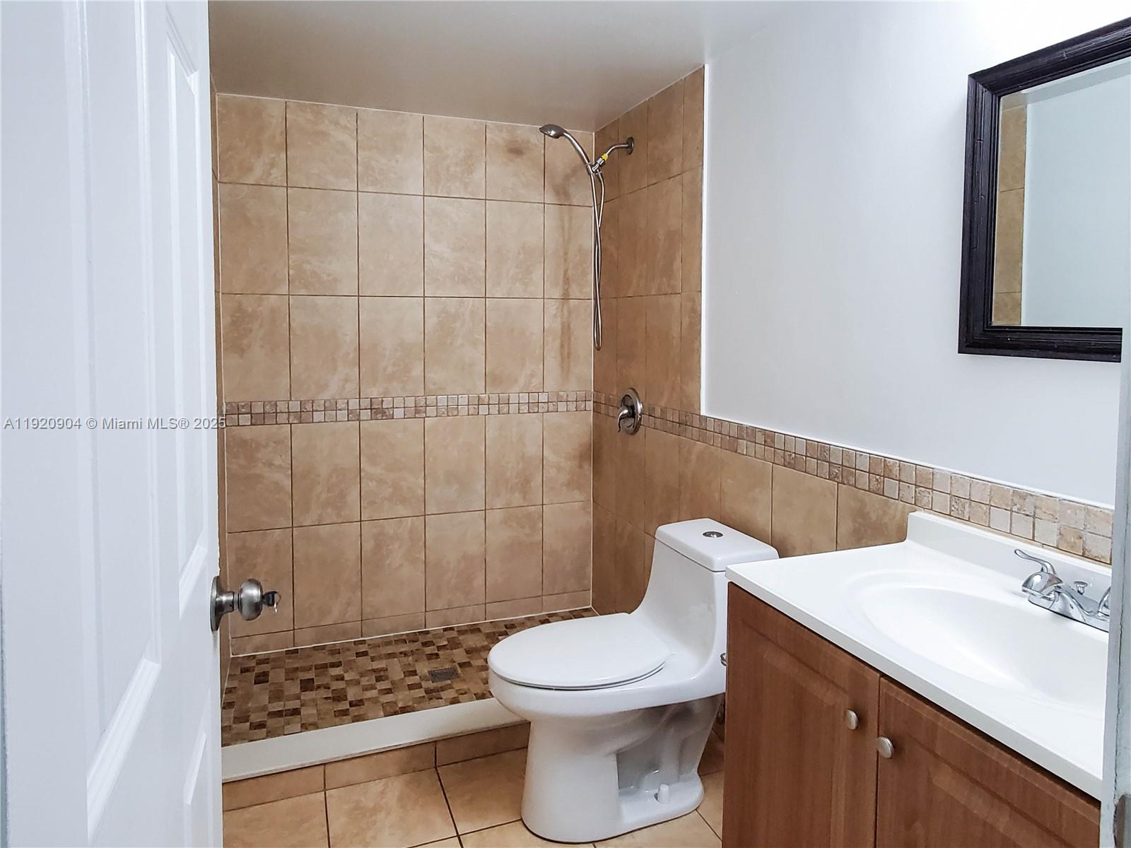 6065 Northwest 186th Street, Unit 106 Hialeah, FL 33015 - Photo 12 of 20 a bathroom with a sink a toilet and shower